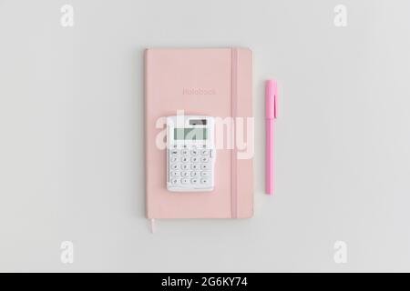 Calculator, notebook and pen on grey background. Top view. Flat lay. Back to school concept. Stock Photo
