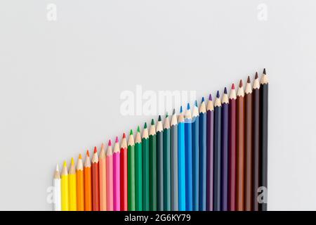 Colored pencils on grey background. Top view with copy space. Flat lay. Back to school concept. Stock Photo