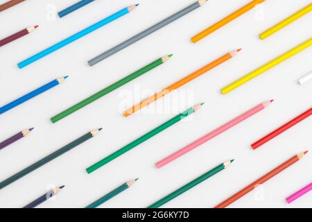 Pattern composition of colored pencils on a grey background. Top view. Flat lay. Back to school concept. Stock Photo