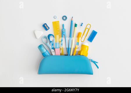 Pencil case with school stationery on a grey background. Top view. Flat lay. Back to school concept. Stock Photo