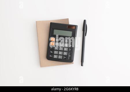 Calculator, notebook and pen on a white background Stock Photo
