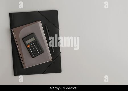 Calculator, notebook and pen on a white background Stock Photo