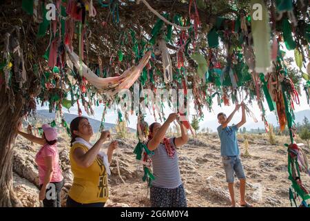 Elmali,Antalya,Turkey - 06-23-2016:A multicolored traditional wish tree in the village of Tekke Stock Photo