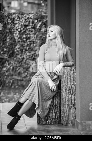 In her own style. must-have skirt. trendy girl wear corrugated skirt. pleated skirt collection. woman warm autumn skirt sit outdoor. relax while Stock Photo