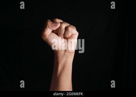 hands clenched power strength isolated on black , Stock Photo