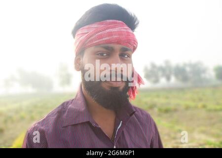 Indian Young Rural Farmer  Standing in agricultural field Stock Photo