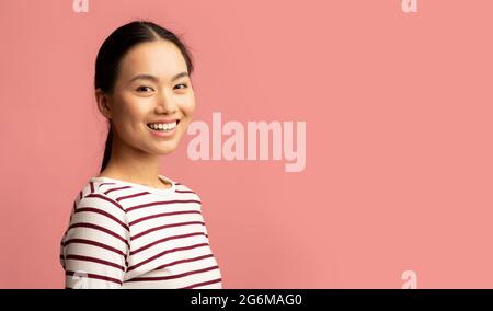 Portrait Of Beautiful Millennial Asian Woman Posing Over Pink Background Stock Photo