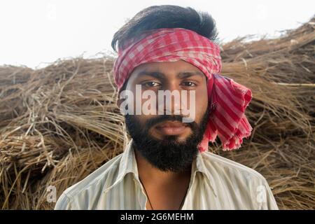 Indian Young Farmer Standing on his agriculture field Stock Photo