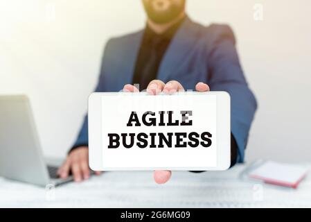 Conceptual caption Agile Business. Word Written on capability of adjusting quickly to the market s is trend Tech Guru Selling Newly Developed Device Stock Photo