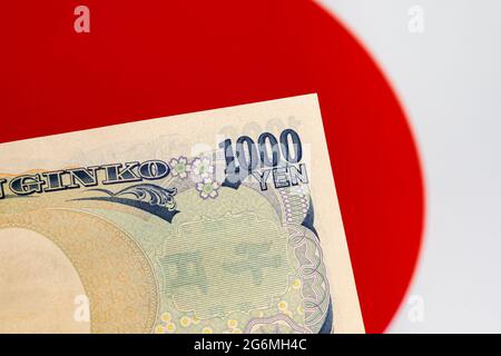 Japan 1000 yen money and flag. Concept of Japanese trade war, economy and financial market Stock Photo