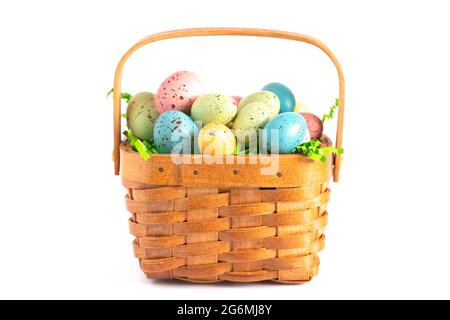 A Wooden Easter Basket Filled with Decorated Eggs Isolated on a White Background Stock Photo