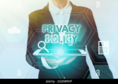 Sign displaying Privacy Policy. Business showcase Documentation regarding the management of the client s is data Woman In Suit Standing Using Device Stock Photo