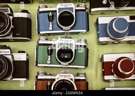 DOESBURG, THE NETHERLANDS - AUGUST 23, 2015: Retro styled image of colorful photo cameras on a flee market in Doesburg, The Netherlands Stock Photo