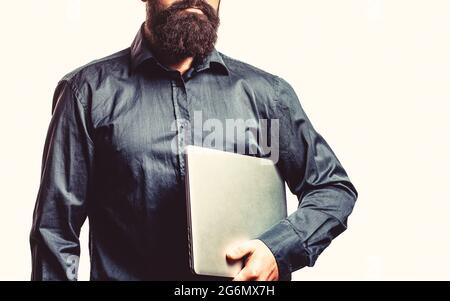 Young businessman using his laptop, pc. Holding laptop computer. Serious handsome bearded man worker laptop Stock Photo