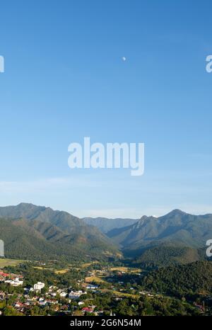 The small village near the end of the runway is located in the plains between the mountains range, view from the viewpoint of the temple on the high m Stock Photo