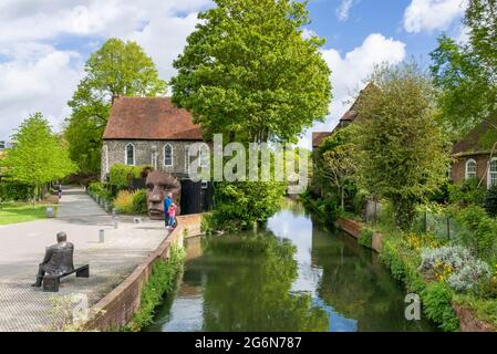 Great Stour river, Mask sculpture and Bronze statue of Dave Lee a famous pantomime dame outside the Marlowe theatre Canterbury Kent England UK GB Stock Photo