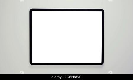 A tablet with black frame and blank white screen, isolated modern real tab computer 3D with copy space mockup. Stock Photo