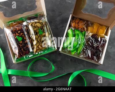 Gift box with set of different dried fruits nuts citrus individually wrapped flat lay. Healthy food diet. Christmas celebration, organic eco natural m Stock Photo