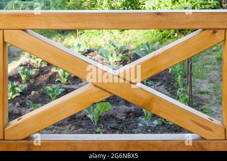A wooden railing of a balcony with wooden columns isolated on white background Stock Photo
