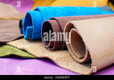 Various pieces of leather in rolls. Pieces of colored leather Stock Photo