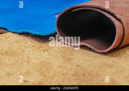 Various pieces of leather in rolls. Pieces of colored leather Stock Photo