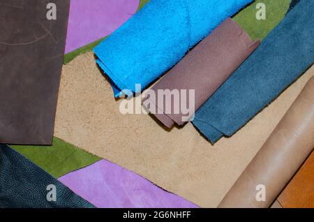 Various pieces of leather in rolls. Pieces of colored leather. View from above Stock Photo