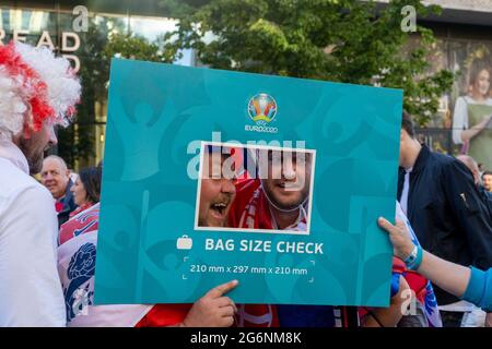 London, UK. 7th July 2021. England fans use the Euro 2020 bag sizer as a selfie frame. Credit: Thomas Eddy/Alamy Live News
