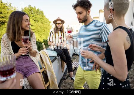 Stylish friends at party on the roof terrace Stock Photo