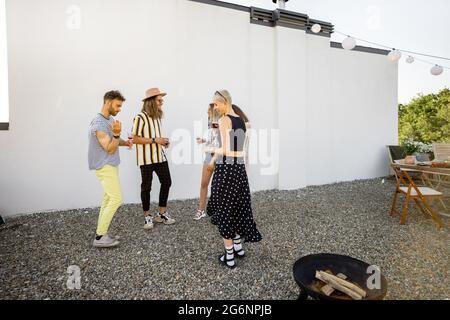 Stylish friends dancing at party outdoors Stock Photo