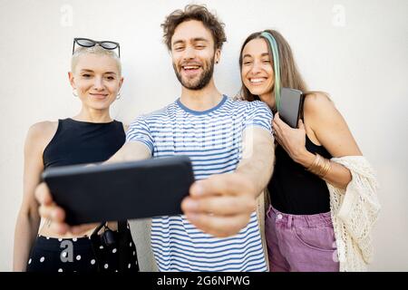Stylish friends taking selfie photo on phone Stock Photo