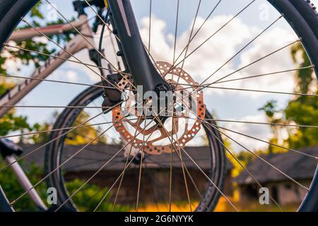 Close-up on a front bicycle wheel, another bicycle in the background Stock Photo