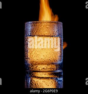 sweated glass of vodka on fire, copy space Stock Photo