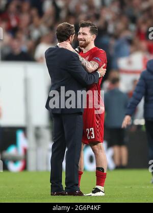 England manager Gareth Southgate embraces Denmark's Pierre-Emile Hojbjerg after the UEFA Euro 2020 semi final match at Wembley Stadium, London. Picture date: Wednesday July 7, 2021. Stock Photo