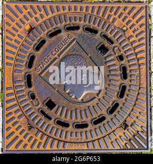 The coat of arms of Coburg's patron saint, Mauritius, appears on every manhole cover in the city of Coburg, Germany. According to legend, Saint Mauritius commanded the Theban Legion from Egypt, which is why he is traditionally depicted with dark skin in heraldry. Stock Photo