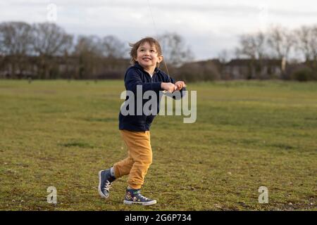 A young boy flying a kite in London Stock Photo