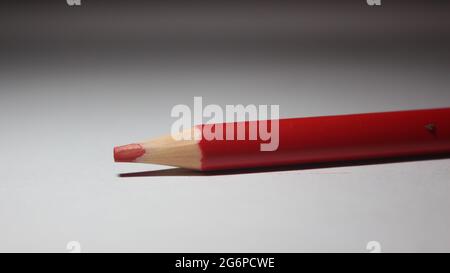 Close up shot of isolated red color pencil on white color background Stock Photo
