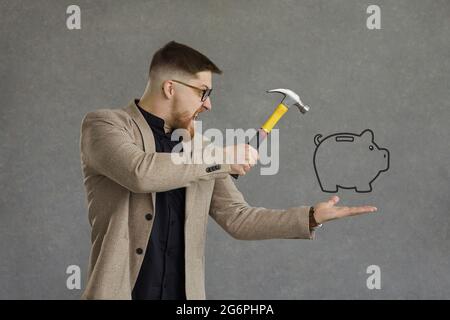 Funny angry crazy young man in need of cash holding hammer over piggy bank doodle Stock Photo