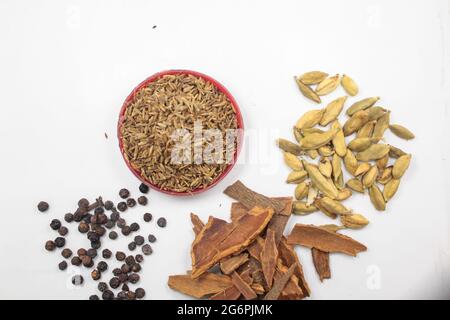 Garam masala ingredients on isolated white surface, new food concept Stock Photo