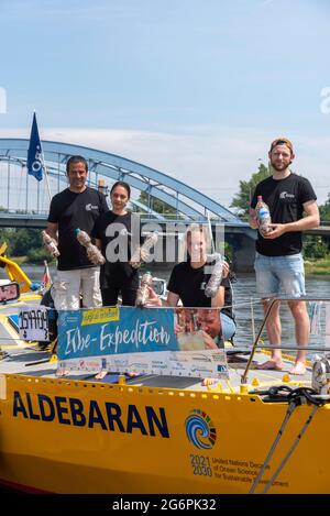 Magdeburg, Germany. 28th June, 2021. The crew of the research vessel 'Aldebaran' shows PET bottles filled with cigarette butts. The scientists are on the Elbe for four weeks to draw attention to the global plastic problem. With the support of numerous environmental initiatives, they are collecting cigarette butts in several cities along the Elbe. This is the largest collection campaign of its kind in Germany. It is intended to draw attention to the fact that carelessly discarded cigarette butts can contaminate river water. Credit: Stephan Schulz/dpa-Zentralbild/ZB/dpa/Alamy Live News Stock Photo