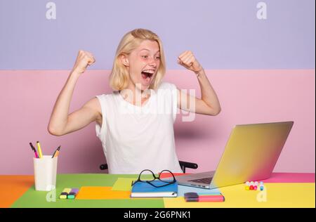 Excited amazed teacher works on laptop. Shcool teacher in class. Professional emotional portrait. Stock Photo