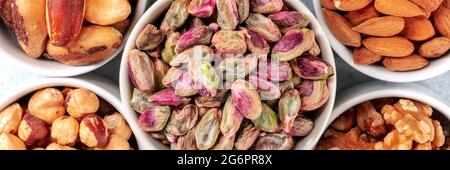 Nuts panorama with pistachios, top shot. Healthy vegan snack Stock Photo