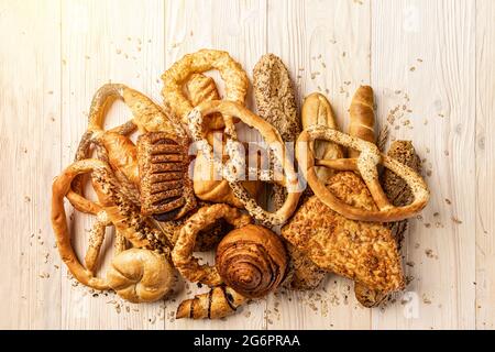 Bakery product assortment with buns, rolls pretzels on wooden background Stock Photo