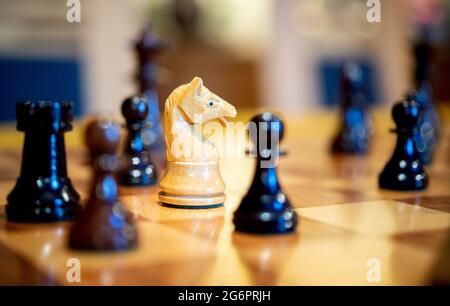 Wardenburg, Germany. 01st July, 2021. Wooden chess pieces stand on a chess board. Chess is a strategic board game in which two players take turns moving chess pieces on a chessboard. The aim of the game is to checkmate the opponent, that is, to attack his king in such a way that it is impossible for him to defend or escape. Credit: Hauke-Christian Dittrich/dpa/Alamy Live News Stock Photo