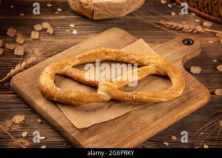 Freshly baked pretzel on wooden background. Bakery product concept Stock Photo