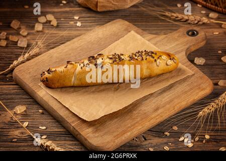 Homemade whole grain bun ready to eat on wooden background Stock Photo