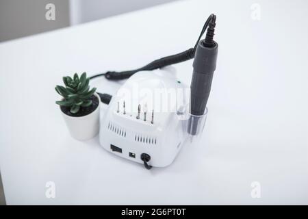 Nail file drill machine on the table at nail salon Stock Photo