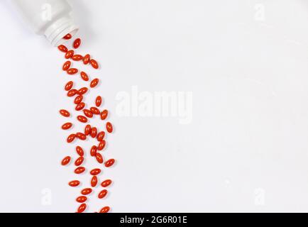 Orange capsules of lutein on a white background with place for text. Supplements and herbal medicine, homeopathy, treatment and prevention Stock Photo