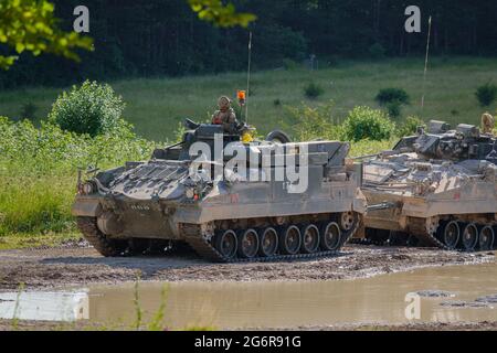 british army FV512 Warrior recover vehicle towing a stricken Warrior FV510 on maneuvers on Salisbury Plain, Wiltshire Stock Photo