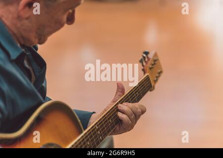 Senior man playing the guitar Stock Photo