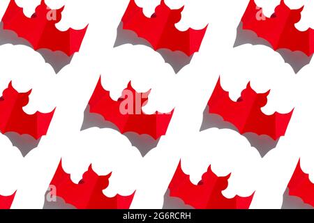 Halloween holiday background red paper bat with hard shadow pattern on white background. Creative minimalism style, trendy minimal greeting card with Stock Photo